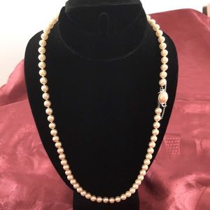 Glass pearl necklace with silver clasp and safety chain